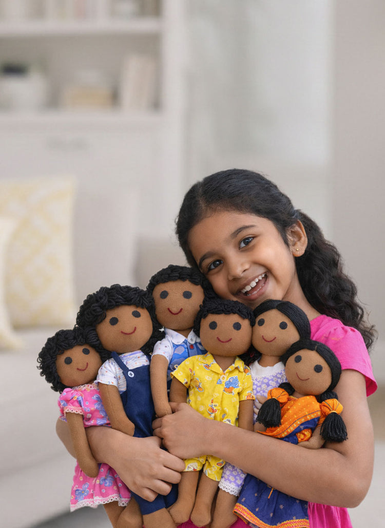 Girl holding a set of diverse dolls in a home setting